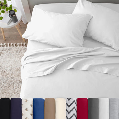 Neatly made bed with white bedding in a bedroom setting.
