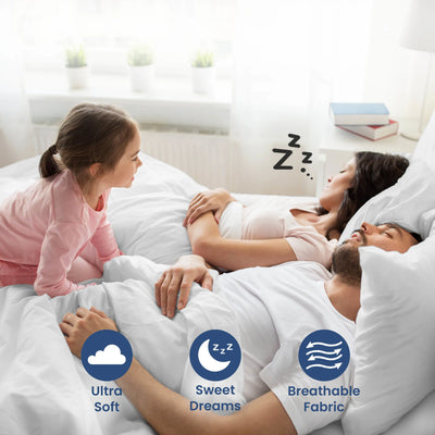 Parent sleeping on a white bedding