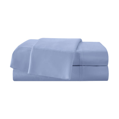 Light blue cotton sheet set with a flat sheet and fitted sheet stacked neatly.