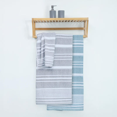 Two striped towels, one gray and white, the other light blue and white, hanging on a wooden rack with a soap dispenser above.