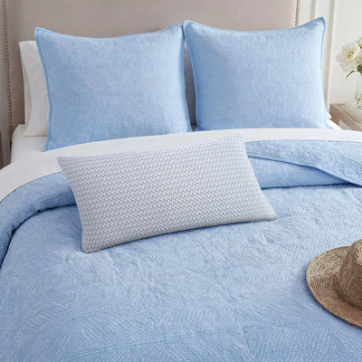 Close up of Blue Southern Tide quilt, shams and a decorative pillow on the bed.