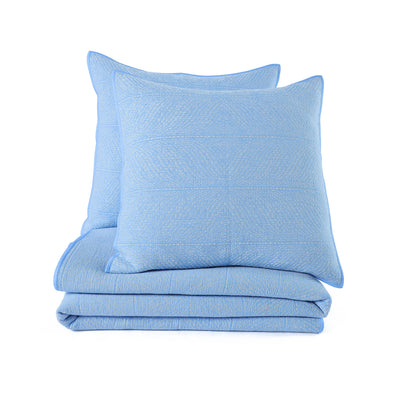Stack shot of blue quilt and sham with a white background.