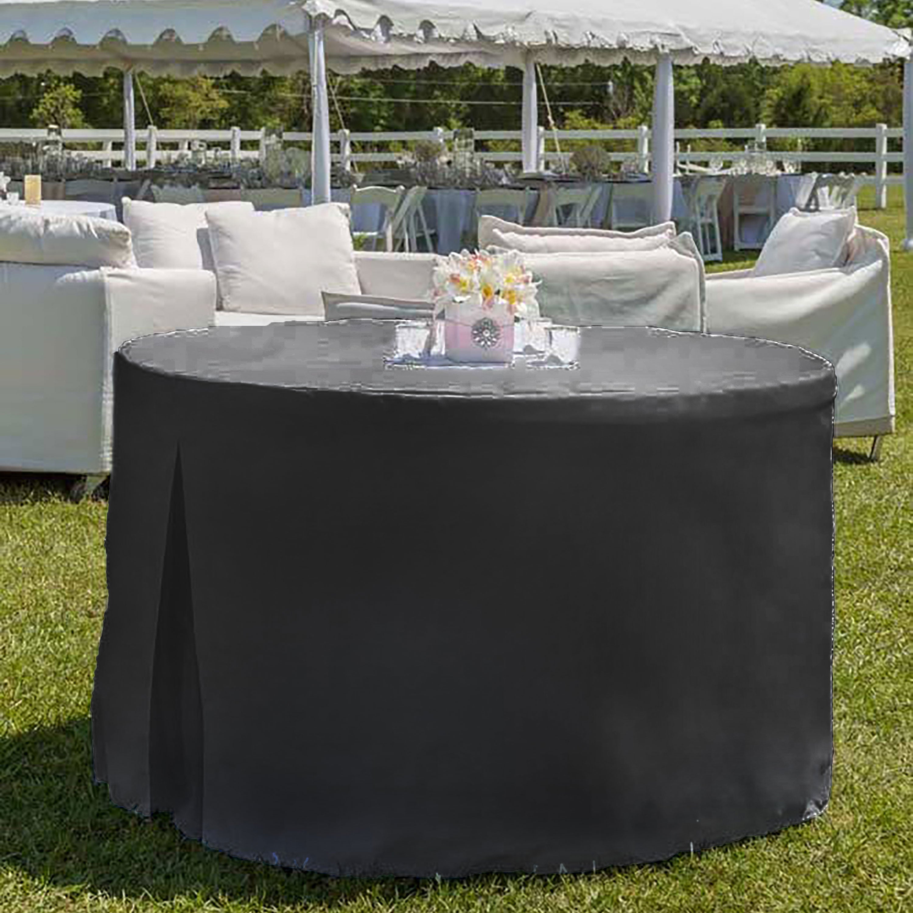 Round black table cover draped over a 60-inch table in an outdoor setting with seating and decorations.