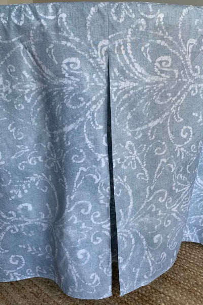 Round table cover with a light blue and white swirling pattern, featuring a slit for easy access.