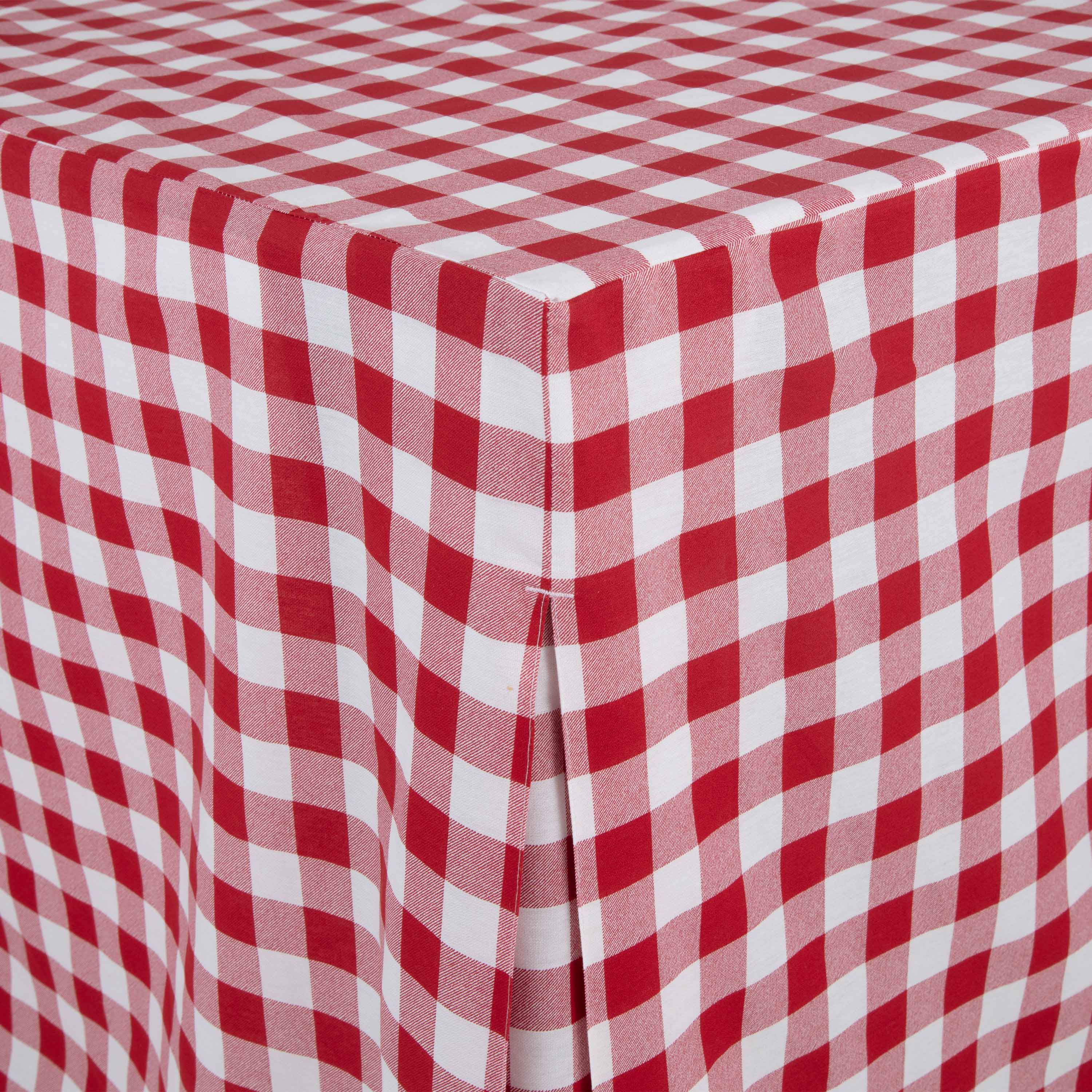 Red and white checkered table cover draping over a round table with a smooth edge.