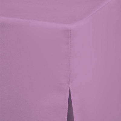 Round table cover in light purple fabric with a corner seam and a slit detail.
