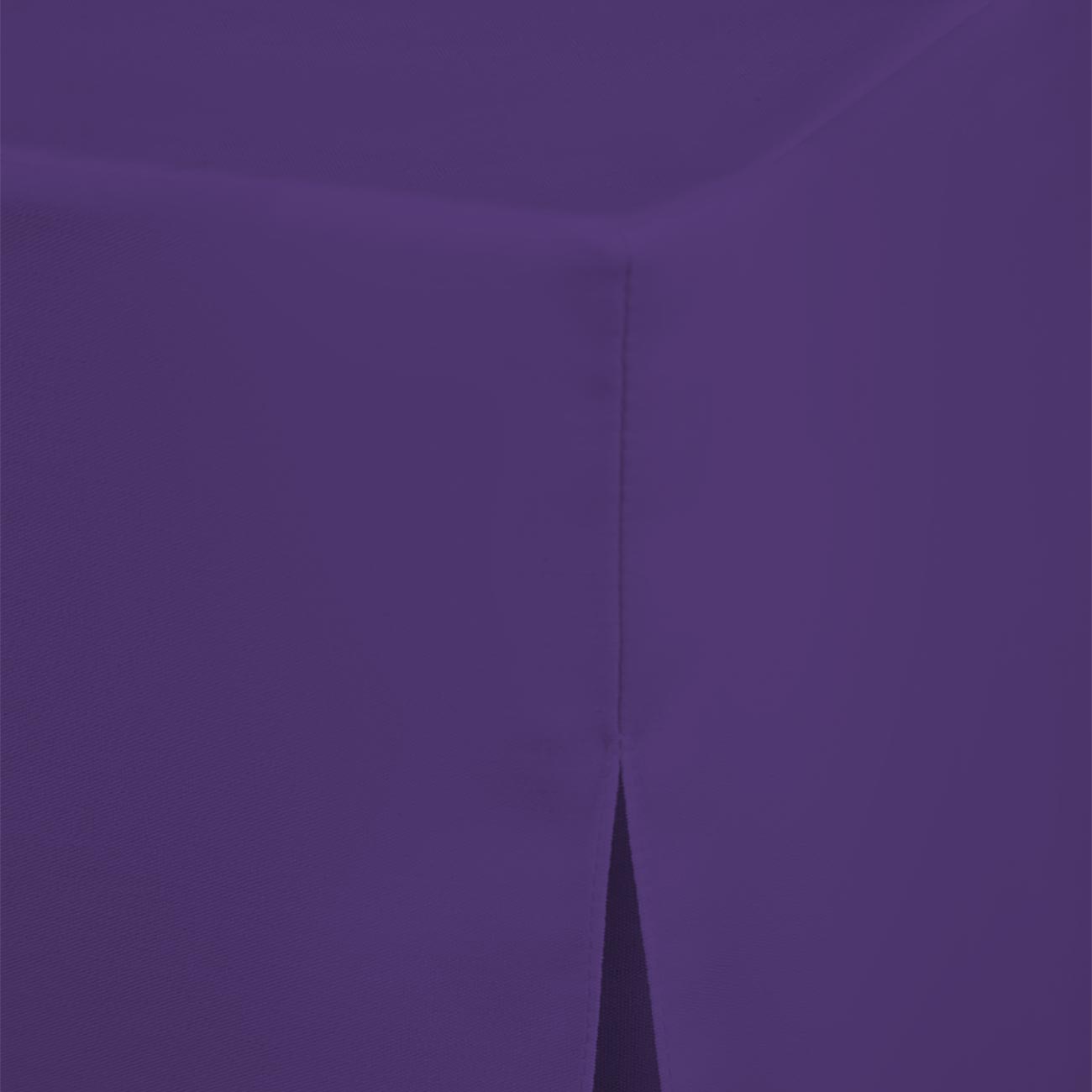 Purple round table cover with a seam and a slight slit at the edge.