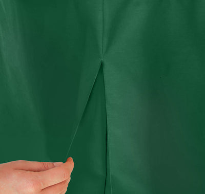 Green table cover with a pleat detail, being held by a hand.