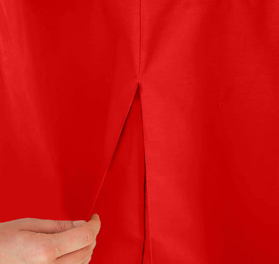 Close-up of a red table cover with a slit, being held by a hand.