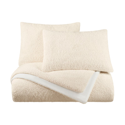 Cream-colored comforter set with a soft, textured surface and two matching pillow shams.