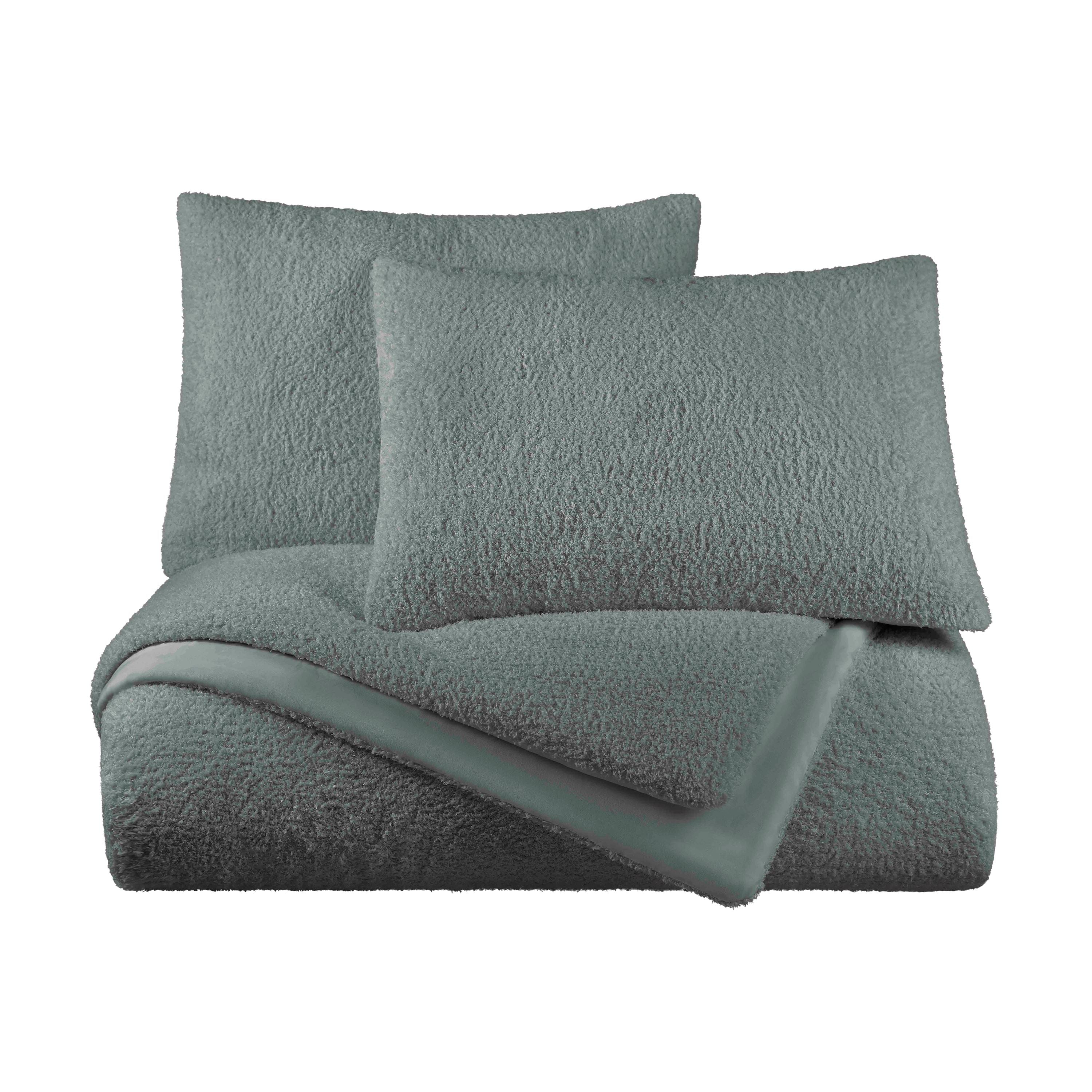 Soft, textured comforter set in a muted teal color with two matching pillows.
