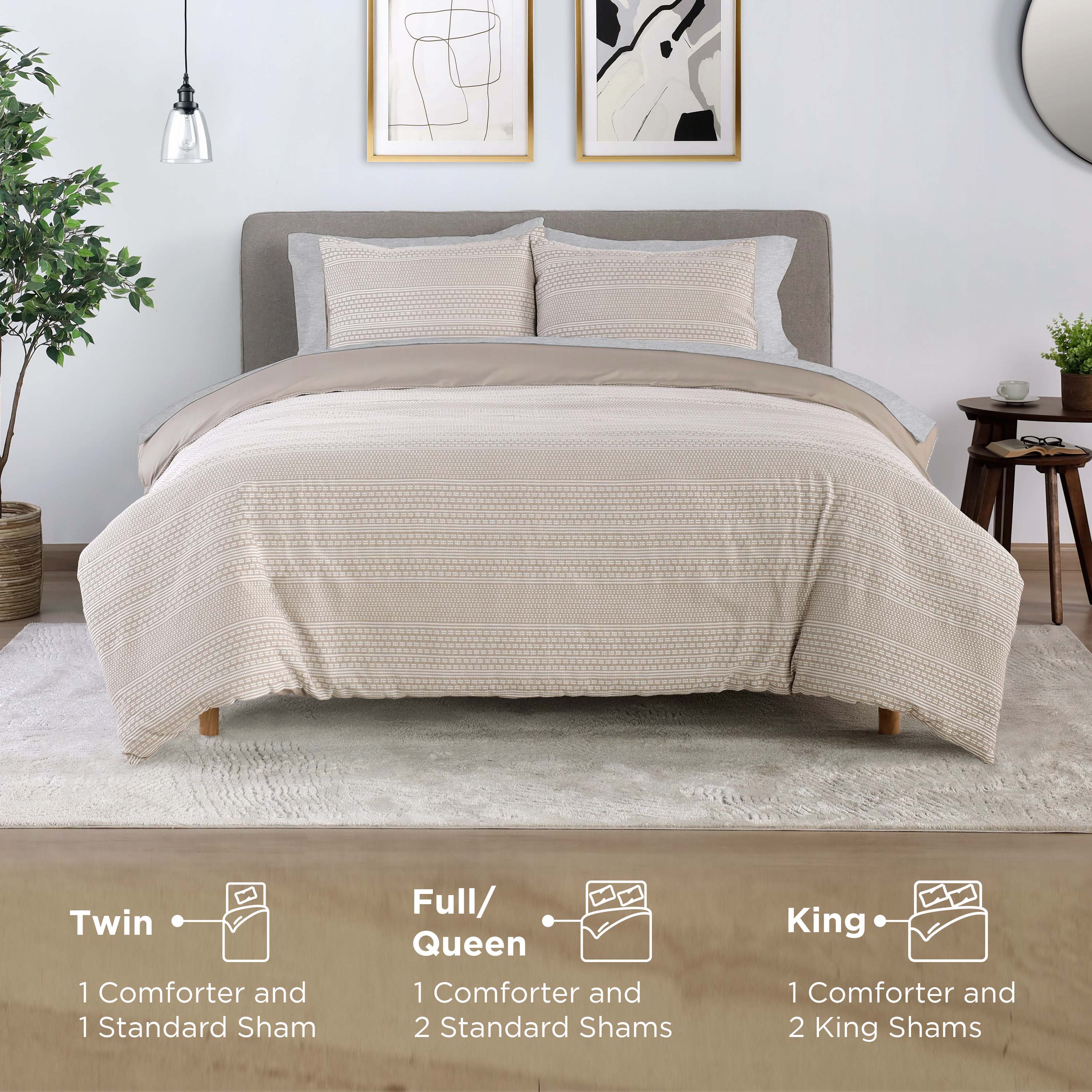 Comforter set displayed on a bed with two standard shams, featuring a textured beige design and a neutral backdrop.