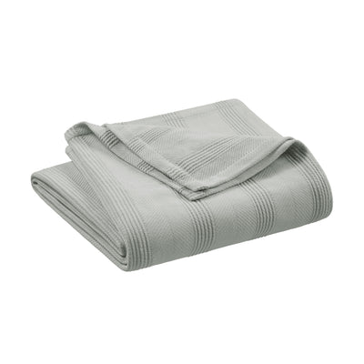 Light gray cotton blanket folded with a textured pattern and a smooth edge.