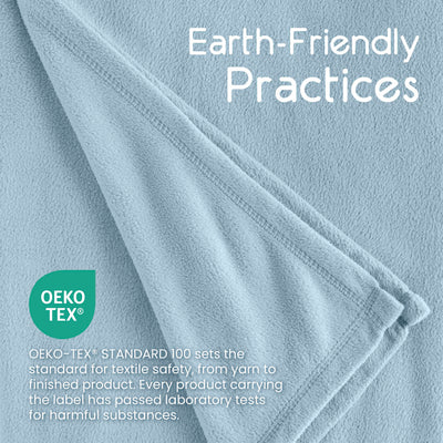 Light blue micro fleece blanket with a soft texture and stitched edges, featuring an OEKO-TEX® label for safety standards.