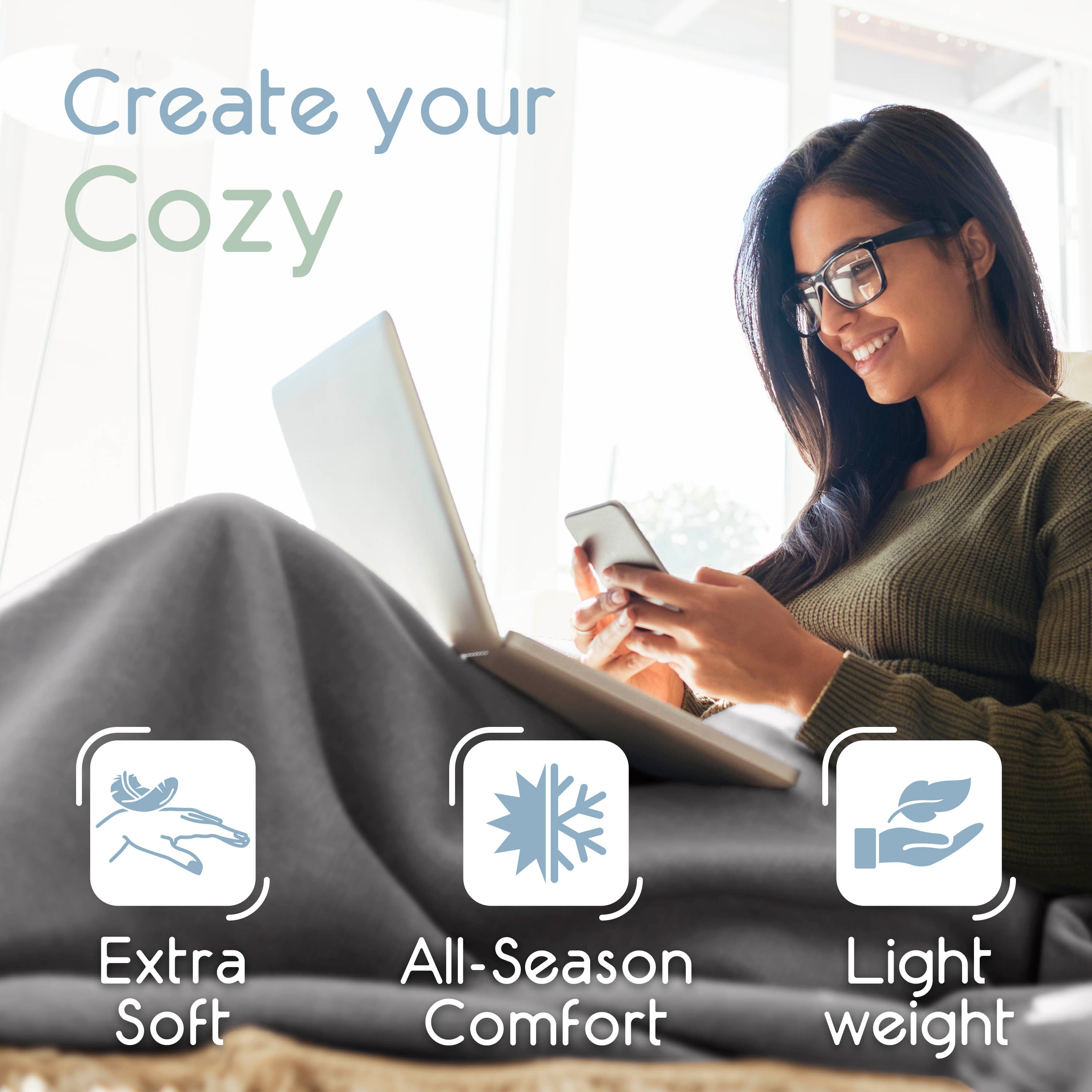 A woman sits comfortably with a laptop and phone, wrapped in a gray micro fleece blanket.