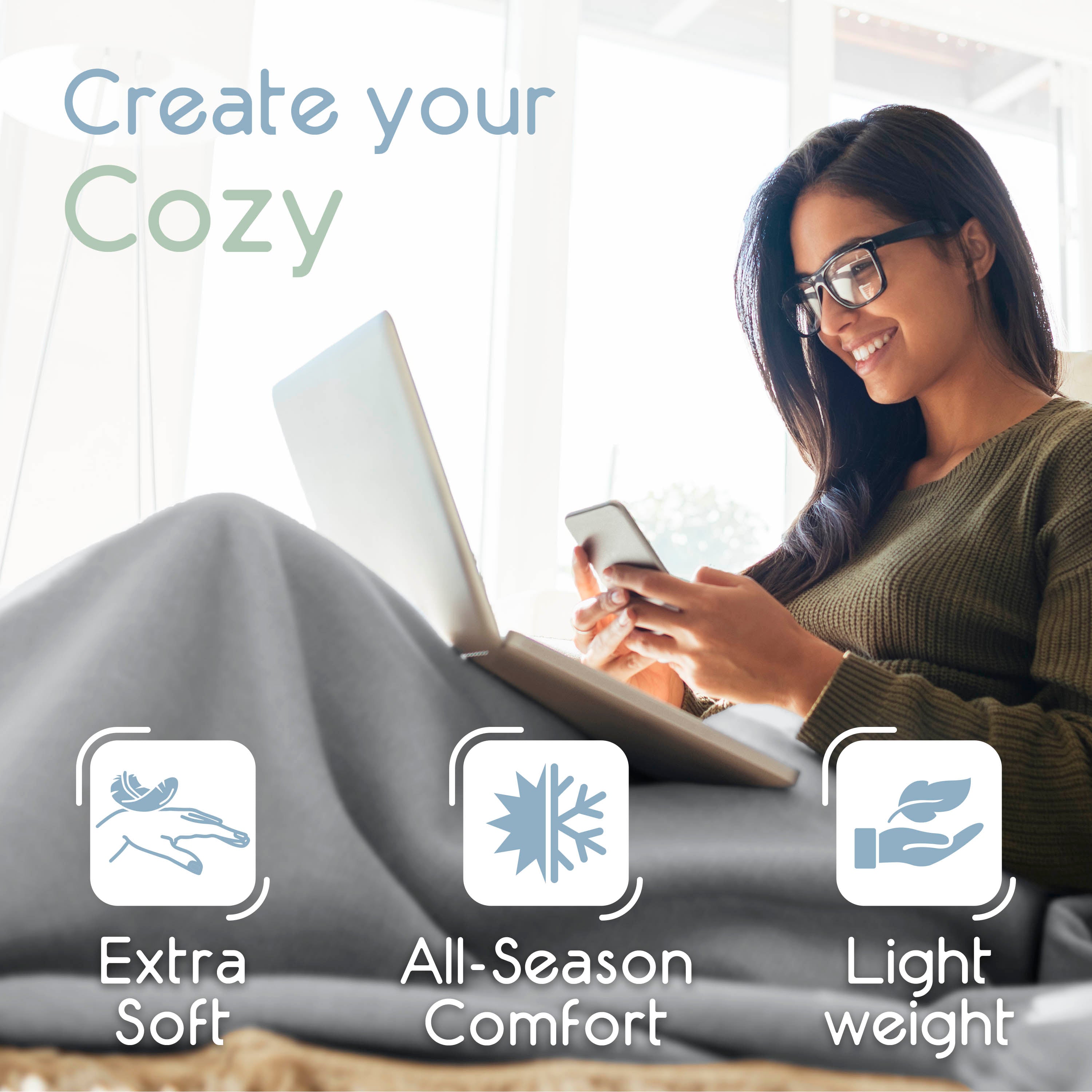 A woman sits comfortably with a laptop and smartphone, covered by a gray microfleece blanket.