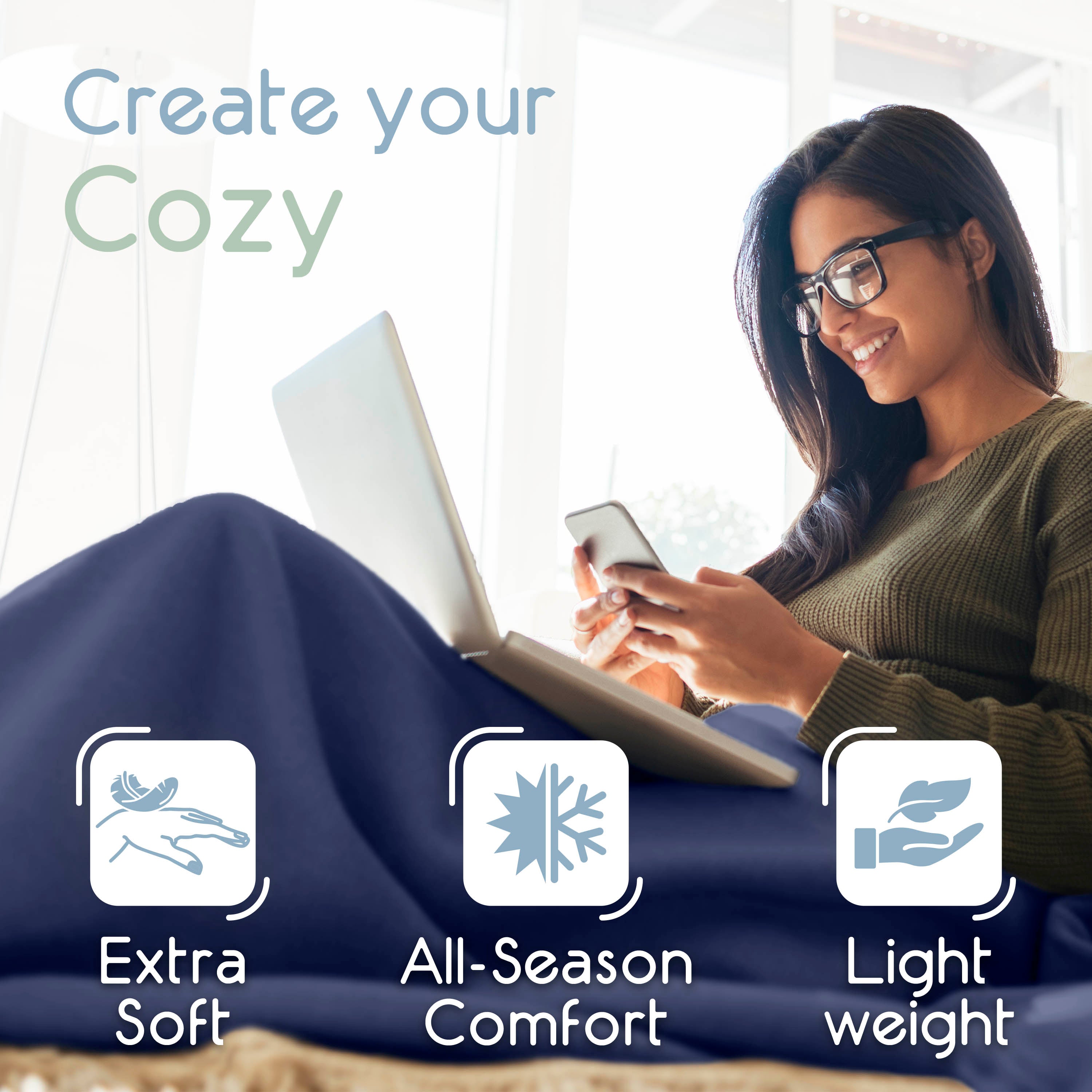 A woman sits comfortably with a laptop and phone, wrapped in a blue micro fleece blanket.