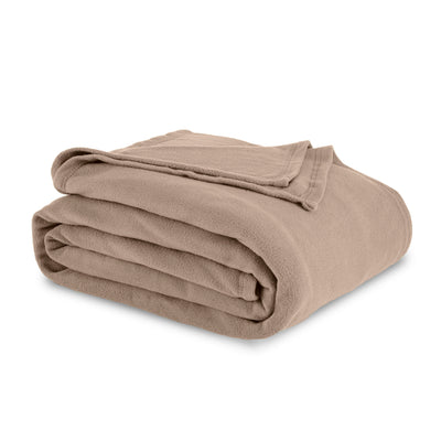 Folded microfleece blanket in a soft beige color with a smooth texture.