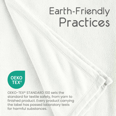White micro fleece blanket with a folded edge, featuring text about earth-friendly practices and Oeko-Tex certification.