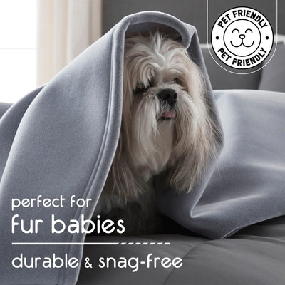 Dog wrapped in a gray blanket with 'Pet Friendly' logo and text about durability and snag-free quality.