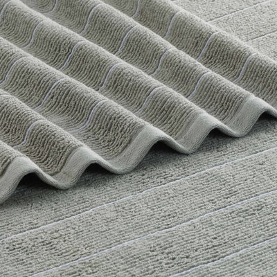 Textured green towel with slub stripe pattern and contrasting light stripes.