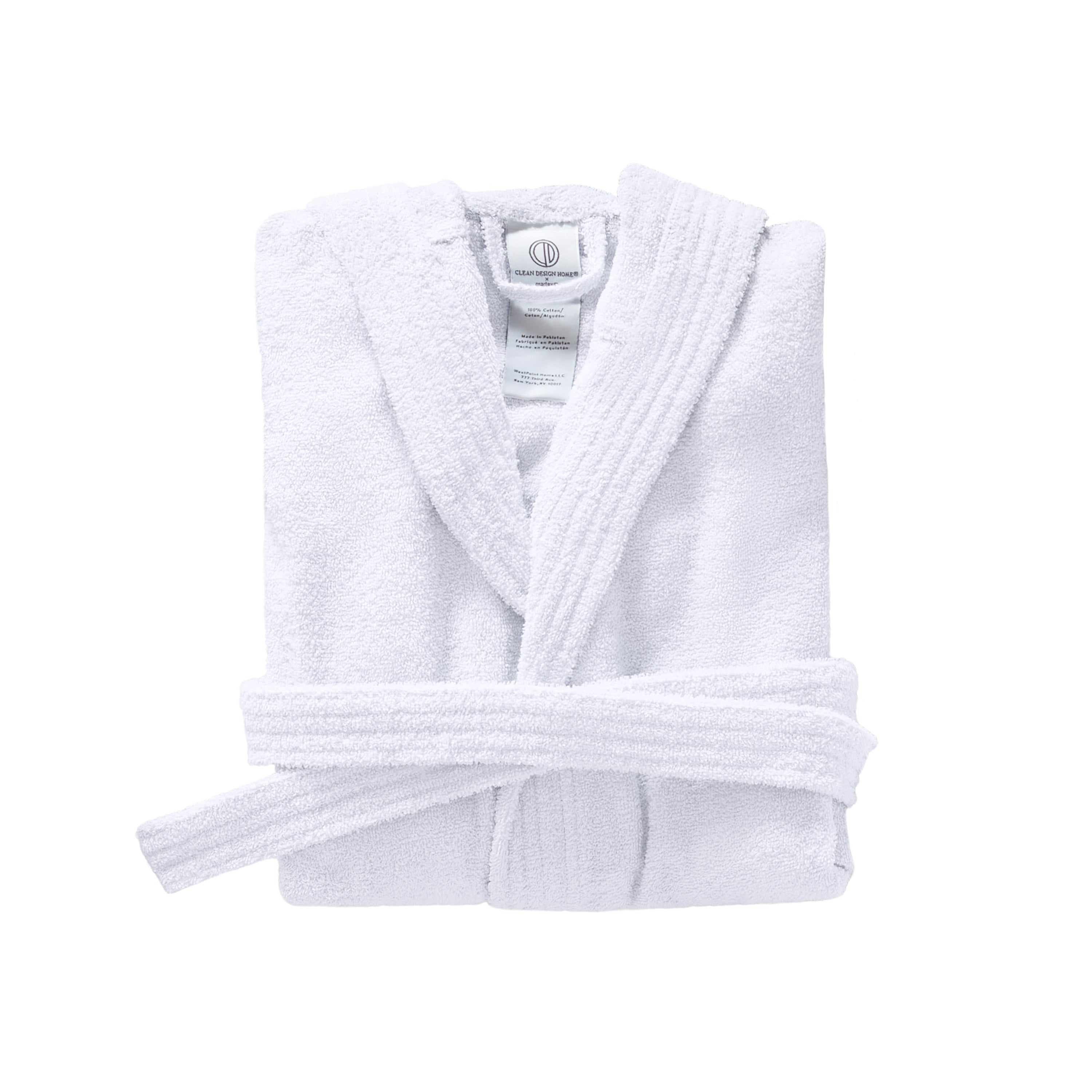 White hooded bath robe folded neatly with a tied belt and textured fabric.