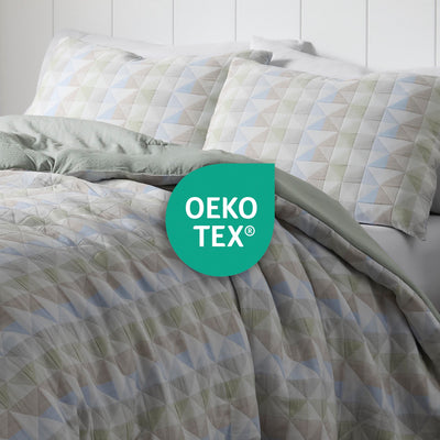 Comforter set featuring a geometric pattern in soft colors with matching pillowcases and an Oeko-Tex certification logo.