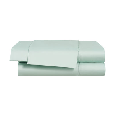 Solid light green cotton and Tencel sheet set, neatly folded with a flat sheet and pillowcases visible.