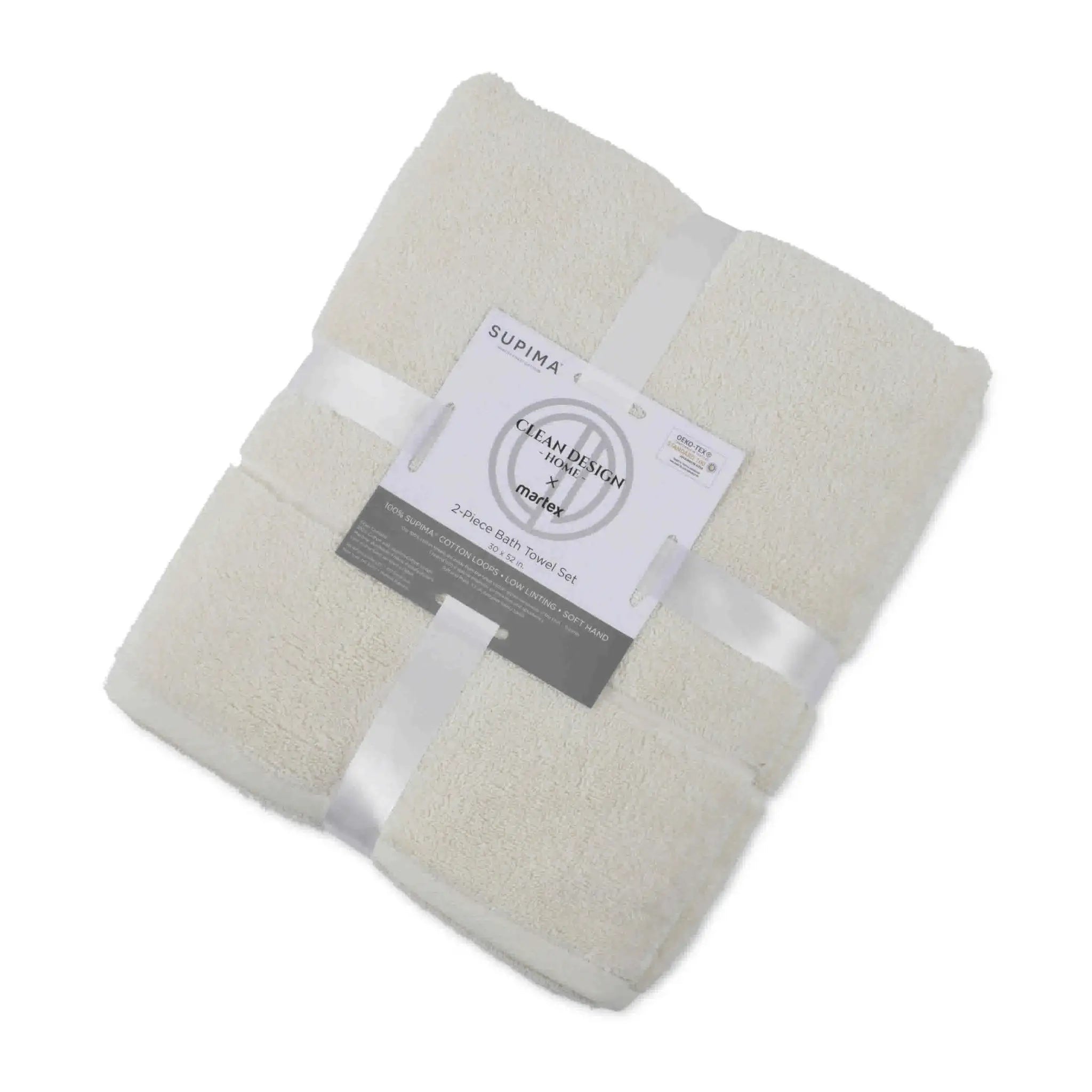 Folded ivory bath towel set with a label on a white background