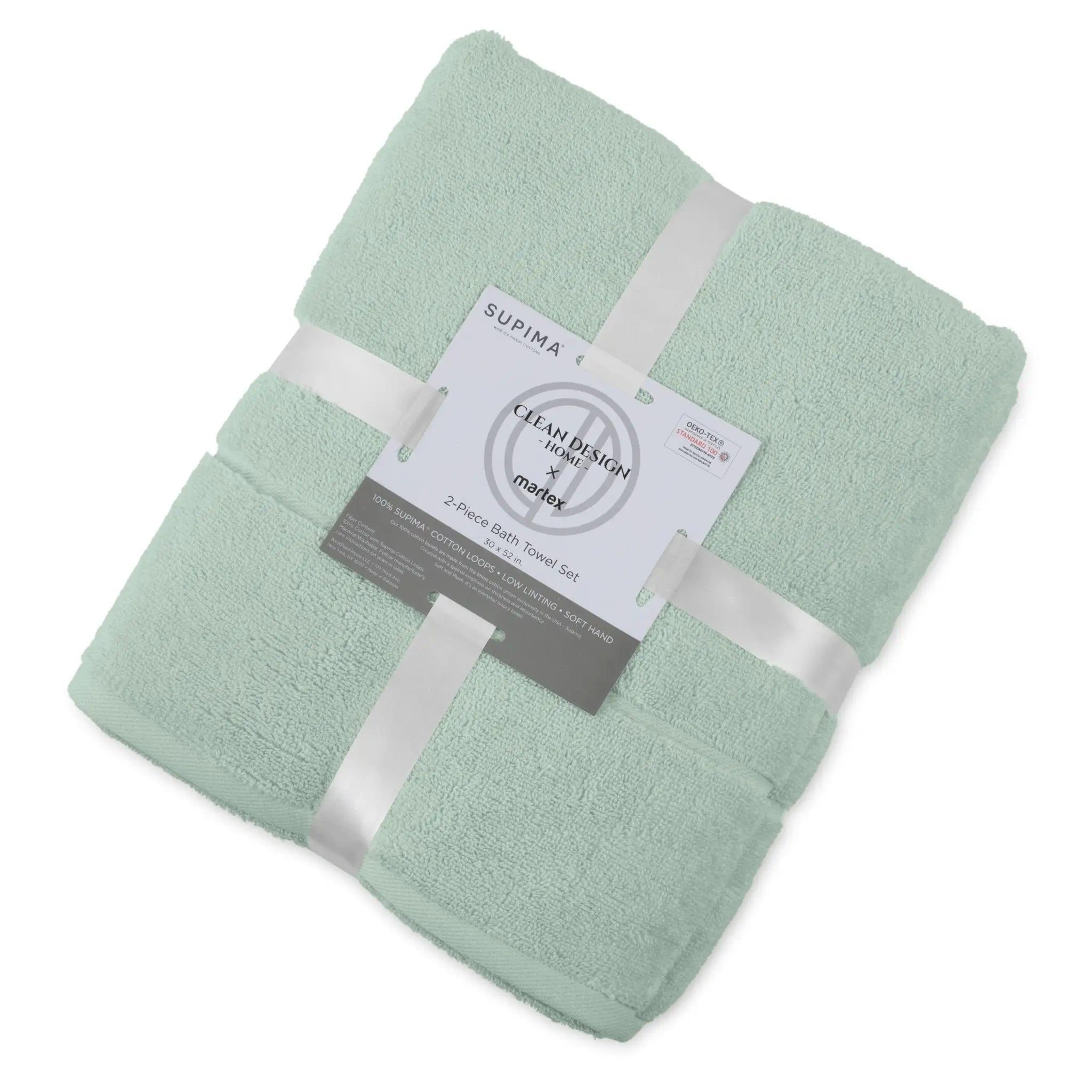 Folded sage bath towel set with a label on a white background