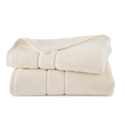 Folded ivory bath towel set on a white background