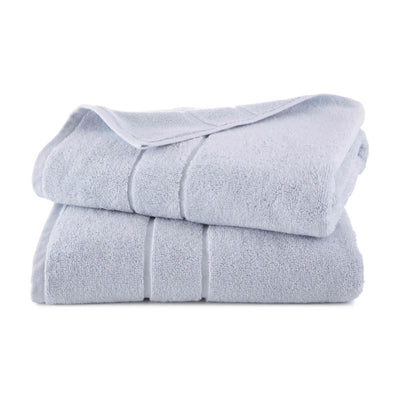 Folded light blue bath towel on a white background