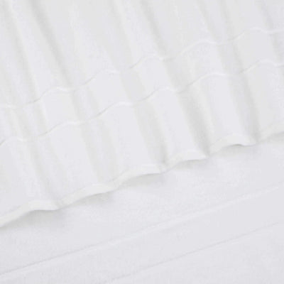 A close-up of a white terry cloth hand towel with a textured striped pattern and folded edges.