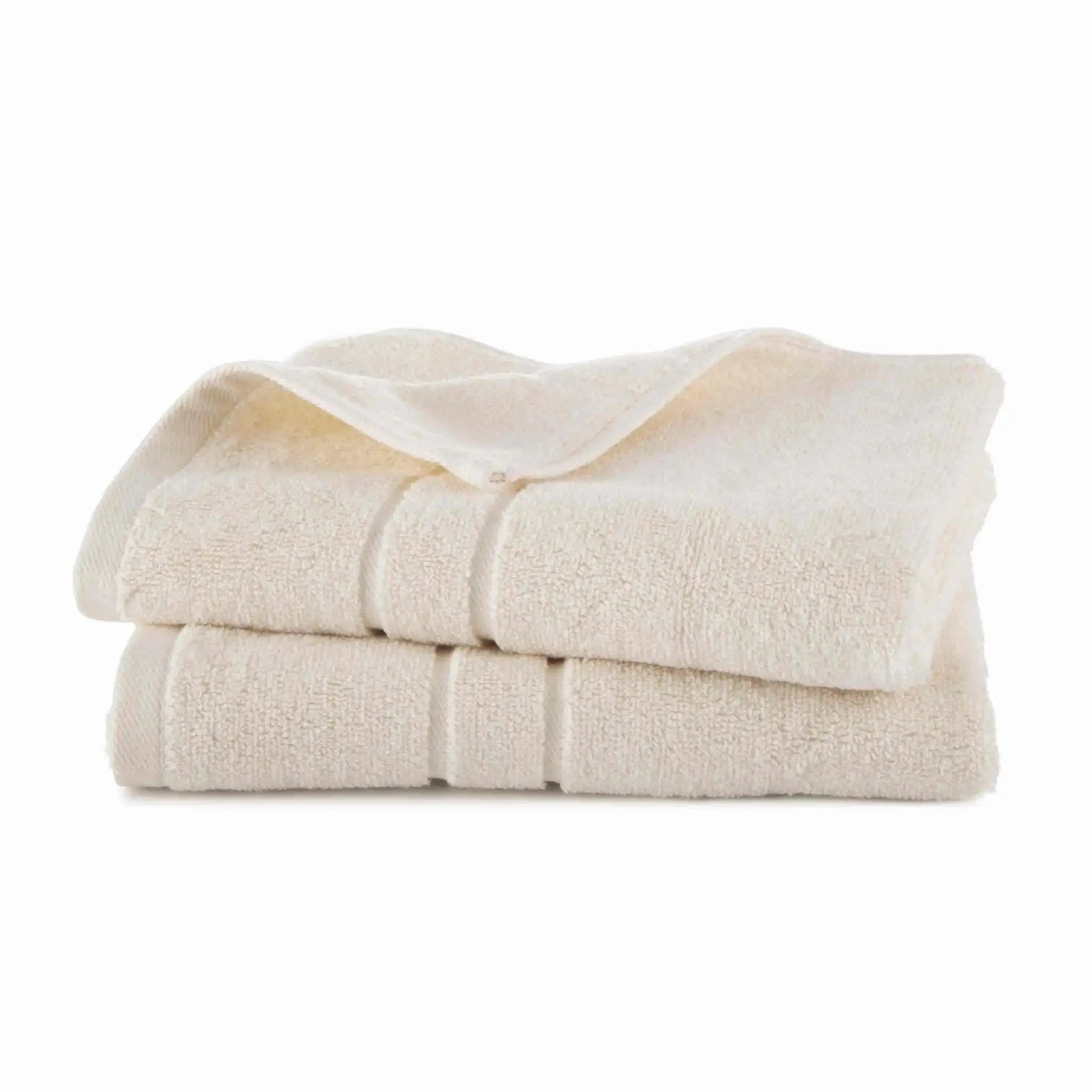 Stack of ivory hand towel set on a white background
