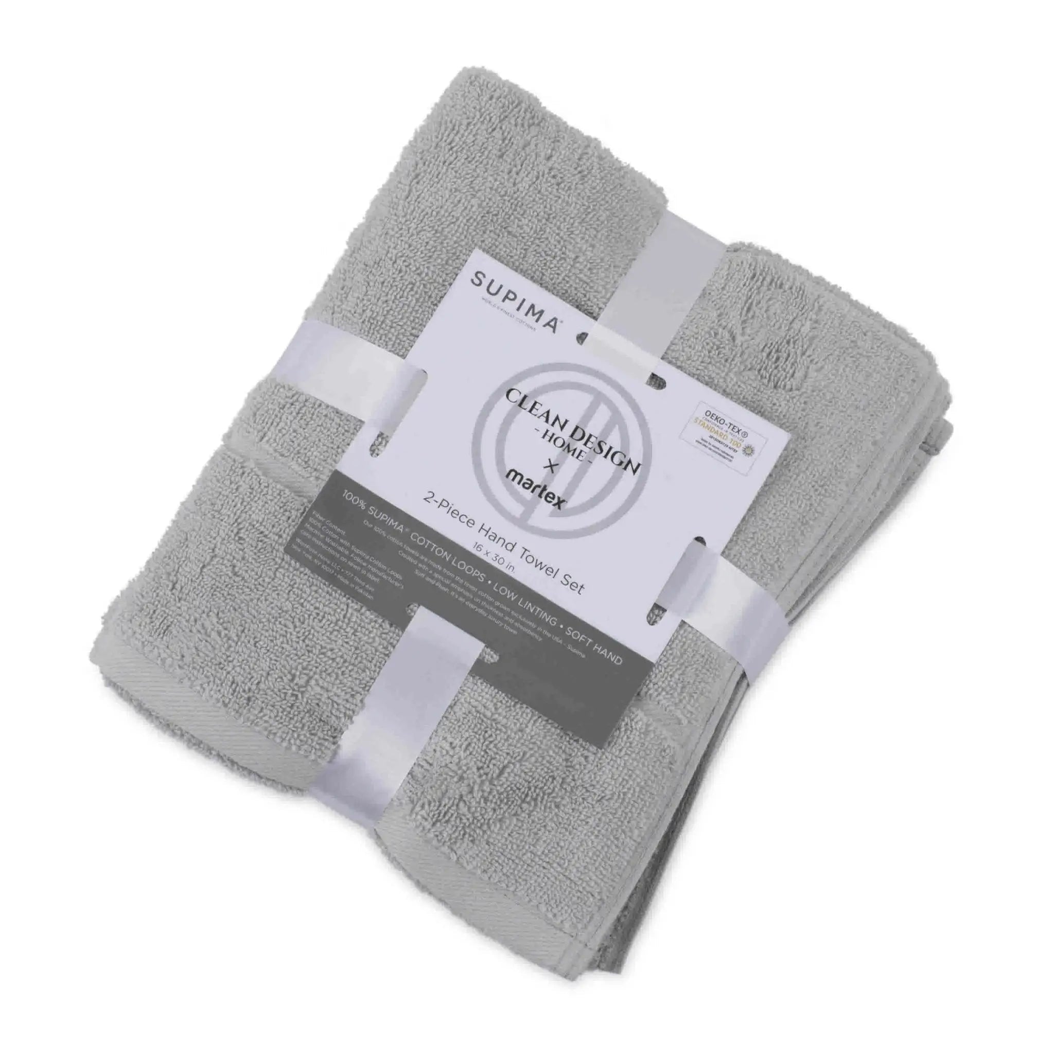 A folded set of two grey terry hand towels wrapped in white ribbons with a paper label that reads 'SUPIMA' and 'Clean Design by Martex'.