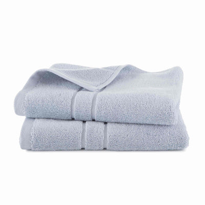 Stack of light blue hand towels on a white background