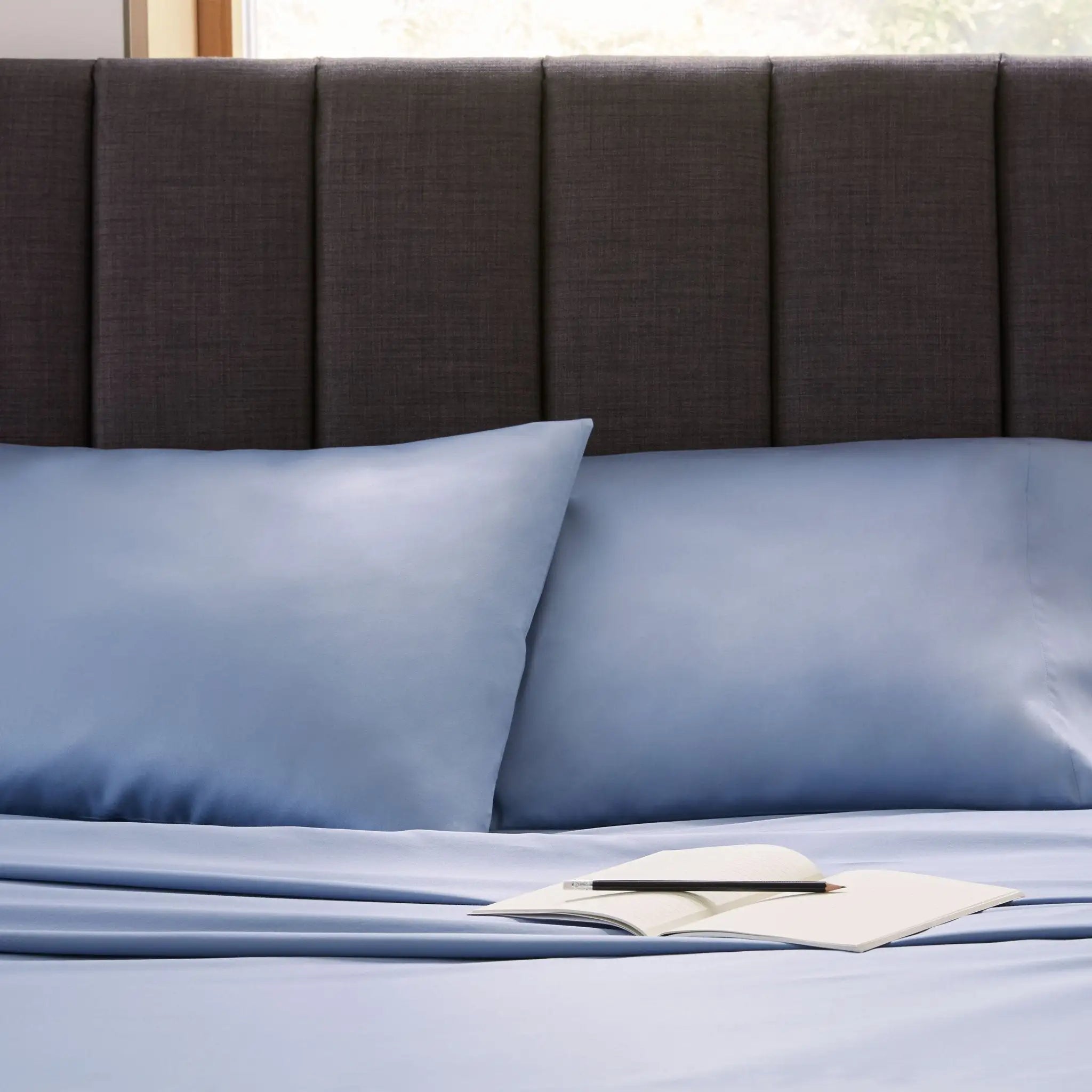 Blue bedding set on a bed.