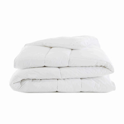 Folded comforter in a white background.