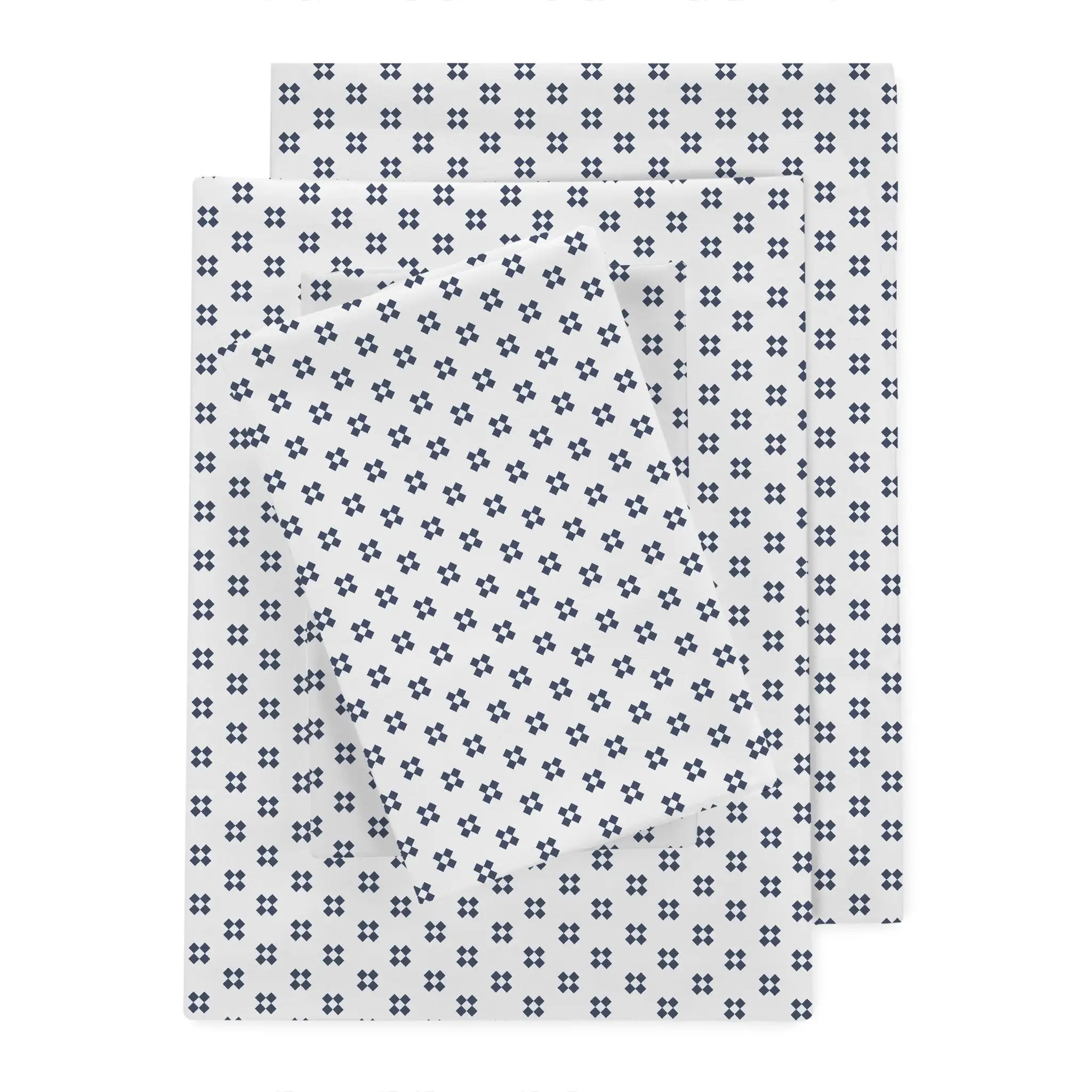 Three rectangular sheets with a repeating navy-blue cross pattern on a white background, arranged in an overlapping stack.