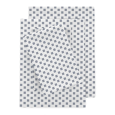 Three rectangular sheets with a repeating navy-blue cross pattern on a white background, arranged in an overlapping stack.