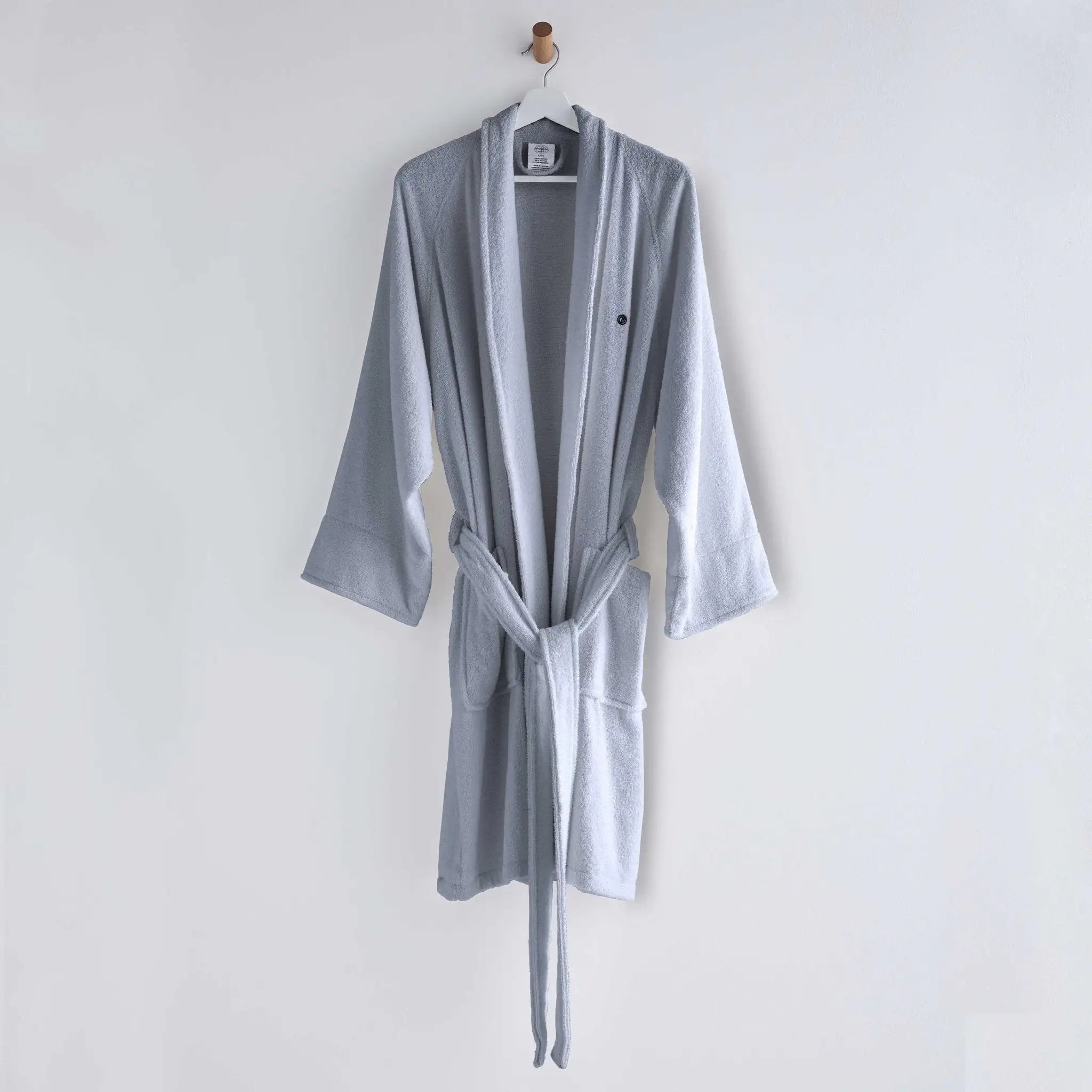 Gray robe hanging on a white wall