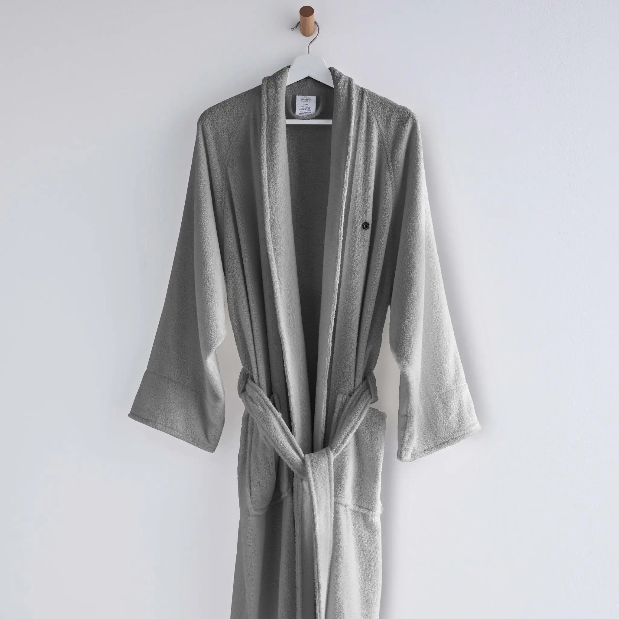 Gray robe hanging on a white wall
