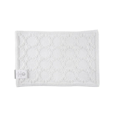 A white textured bath rug, shown on a plain white background.