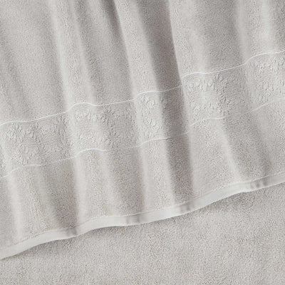 Close-up of a textured gray towel with embroidered details