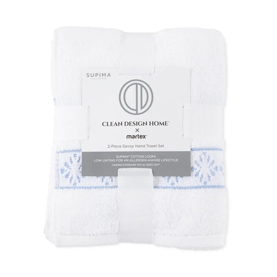 Packaged set of white hand towels with visible branding on a white background