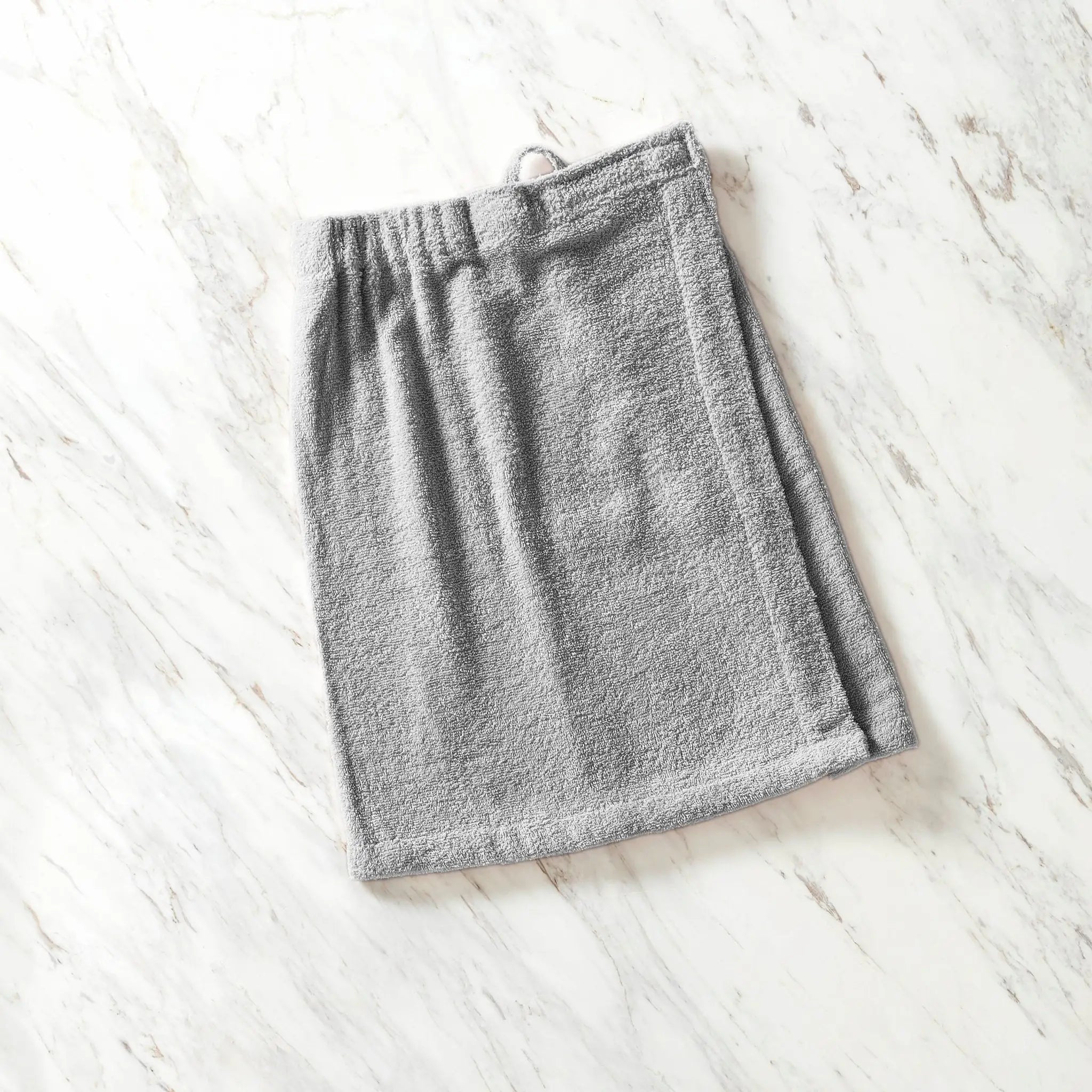 Gray shower wrap on a white wooden surface