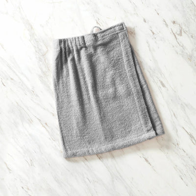 Gray shower wrap on a white wooden surface