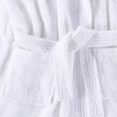 A close-up of a white terry cloth bathrobe with a matching tie belt, showing the soft textured fabric and stitched pocket details.