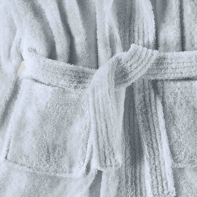 Close-up of a textured blue bathrobe with a belt