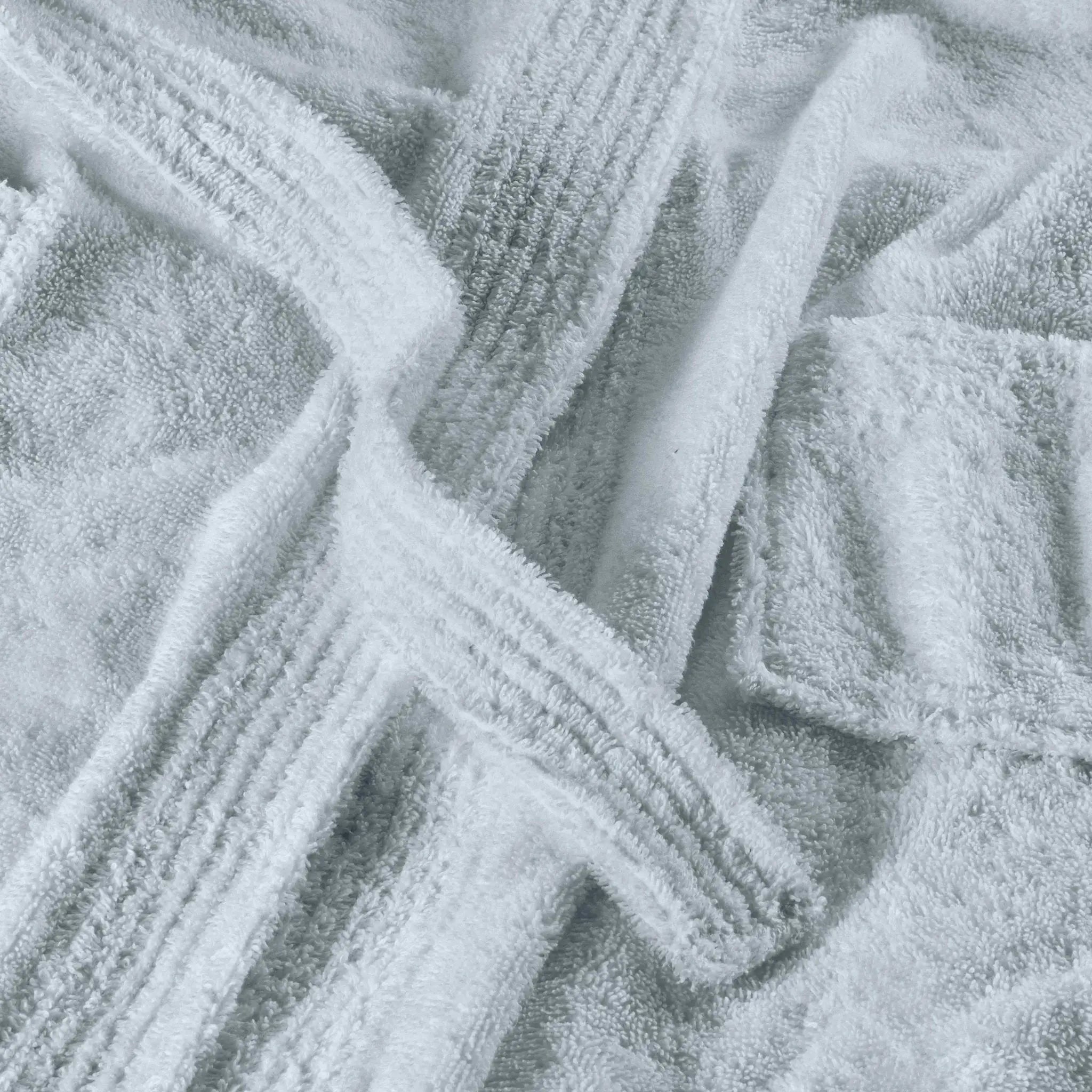 A close-up of a blue plush terry cloth fabric, showing the soft texture and ribbed woven edges.